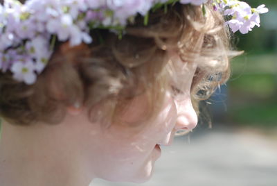 Close-up of woman with pink flower