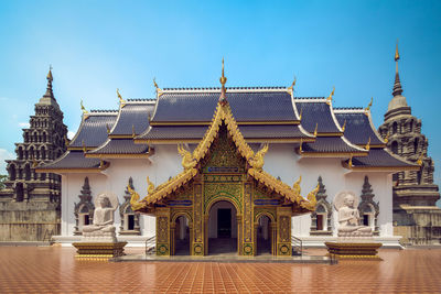 Exterior of buddhist temple against clear blue sky