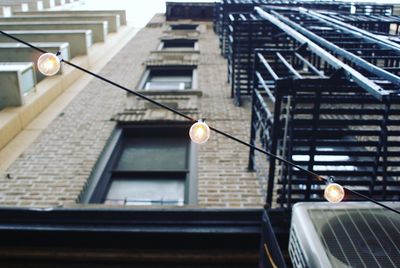 Low angle view of illuminated street light on building