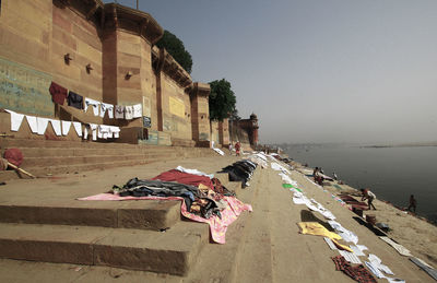 People on building by city against clear sky