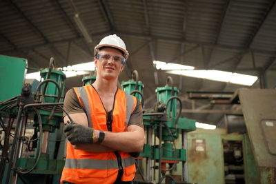 Young man standing in factory