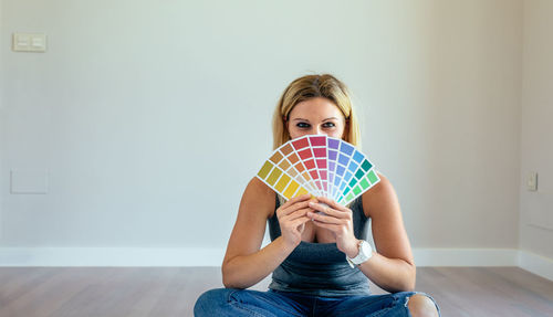 Portrait of young woman sitting at home