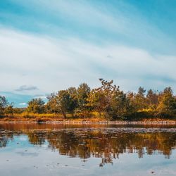 Reflection of trees in lake against sky during autumn