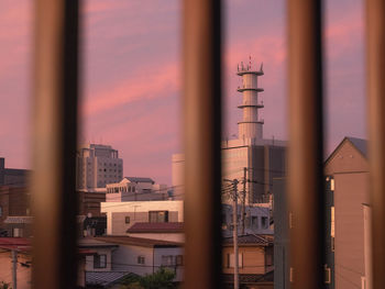 Factory against sky during sunset