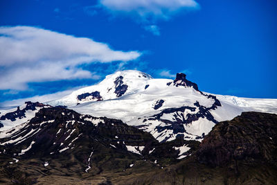 Scenic view of snowcapped mountains against blue sky