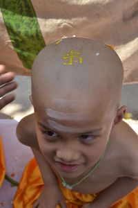 Close-up portrait of boy in religious ceremony