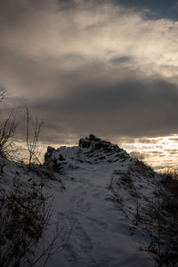 Scenic view of snow covered mountains against sky during sunset