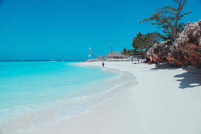 Scenic view of beach against clear blue sky