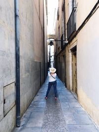 Rear view of woman standing on walkway