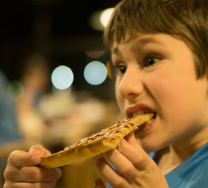 Close-up portrait of boy eating food