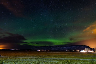 Scenic view of landscape against sky at night