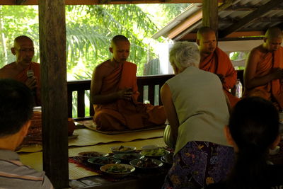 Rear view of people sitting at table