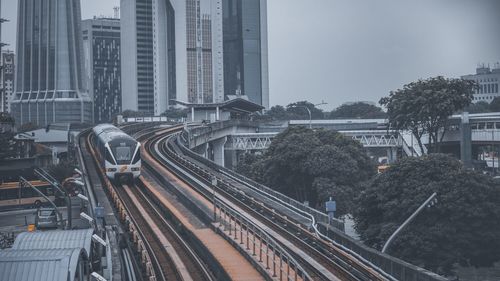 High angle view of railroad tracks amidst buildings in city