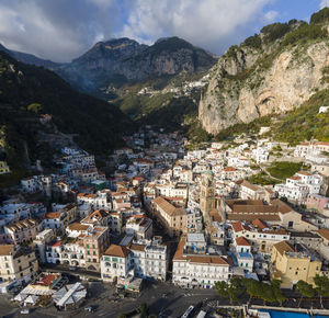 High angle view of townscape and mountains against sky