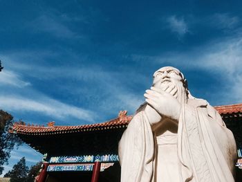 Low angle view of statue against sky