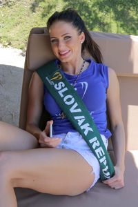 Portrait of a smiling young woman sitting outdoors