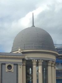 Low angle view of building against cloudy sky