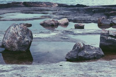 Rocks on shore against sky