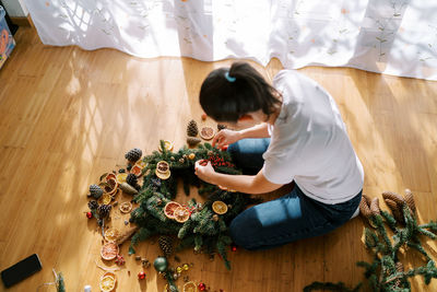 High angle view of girl sitting on table