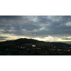 Cityscape against cloudy sky