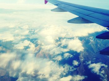 Aerial view of clouds over landscape seen from airplane