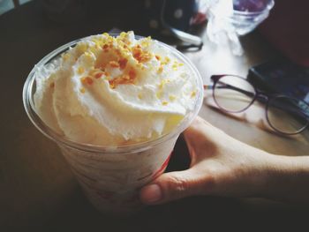 Close-up of hand holding ice cream