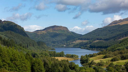 Scenic view of lake and mountains against sky