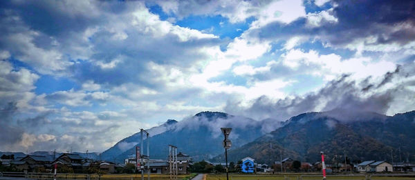 Scenic view of mountains against cloudy sky