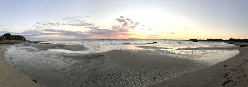 Scenic view of beach against sky during sunset