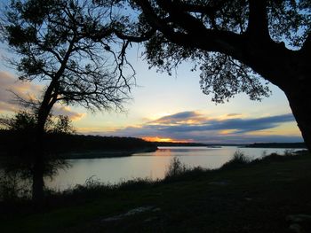 Scenic view of lake against sky during sunset