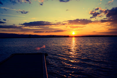 Scenic view of river against sky during sunset