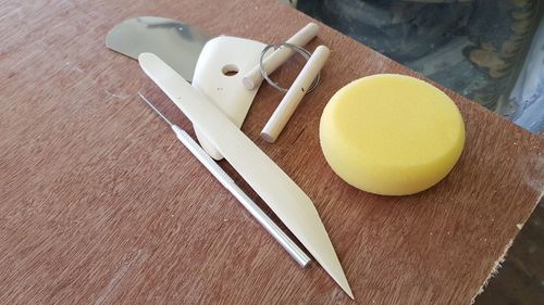 High angle view of pottery tools on table