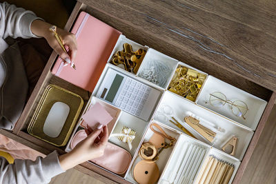 Directly above shot of woman hand holding personal accessories