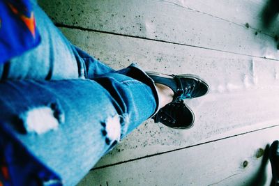 Low section of person standing on tiled floor