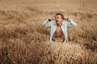 Full length of man standing in field