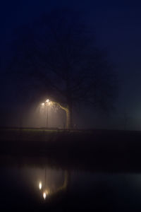 Scenic view of lake against sky at night