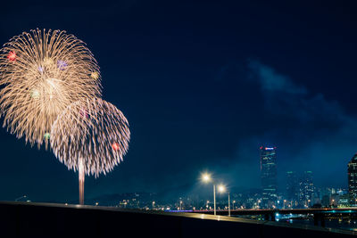 Low angle view of firework display at night