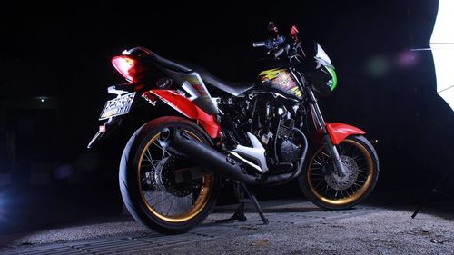 Side view of motorcycle on street at night