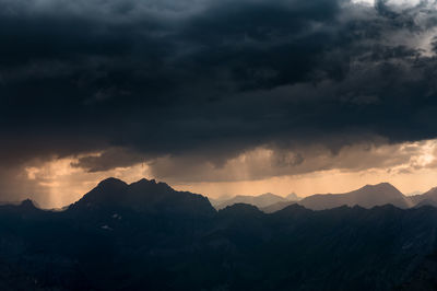 Scenic view of mountains against dramatic sky