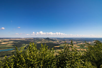 Scenic view of landscape against blue sky