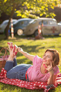 Side view of woman sitting at park