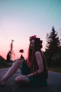 Young woman sitting on field