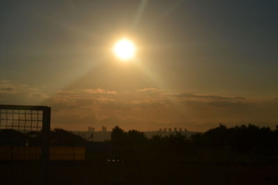 Scenic view of silhouette field against sky during sunset