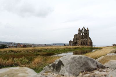 Temple by building against sky
