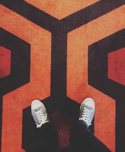 Low section of man standing on tiled floor