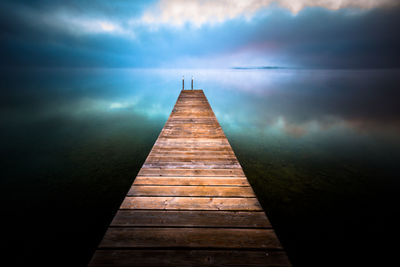 Pier over sea against sky