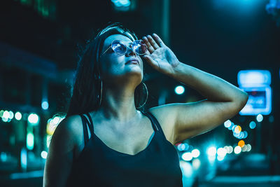 Portrait of young woman standing outdoors