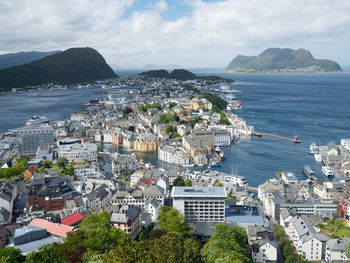 High angle view of townscape by sea against sky