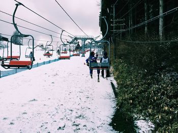 Ski lift against sky during winter