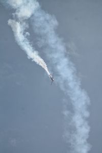 Low angle view of airplane flying against sky